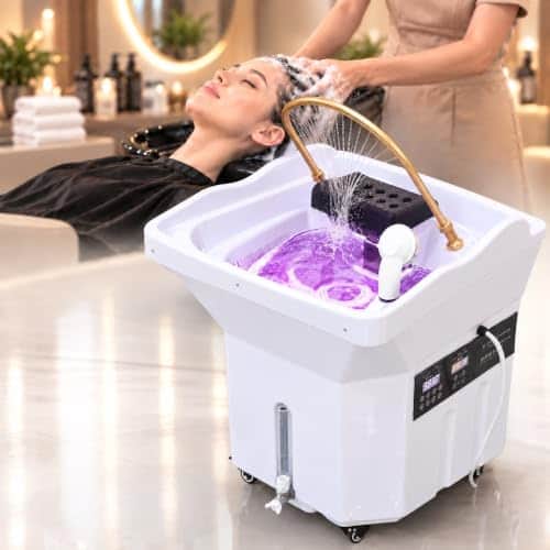 Bac head spa Oberlynova blanc sur roulettes, eau éclairée en violet dans la vasque sous un arceau doré, cliente allongée la tête dans le bac